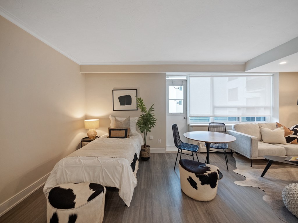 a bedroom with a bed sitting next to a window