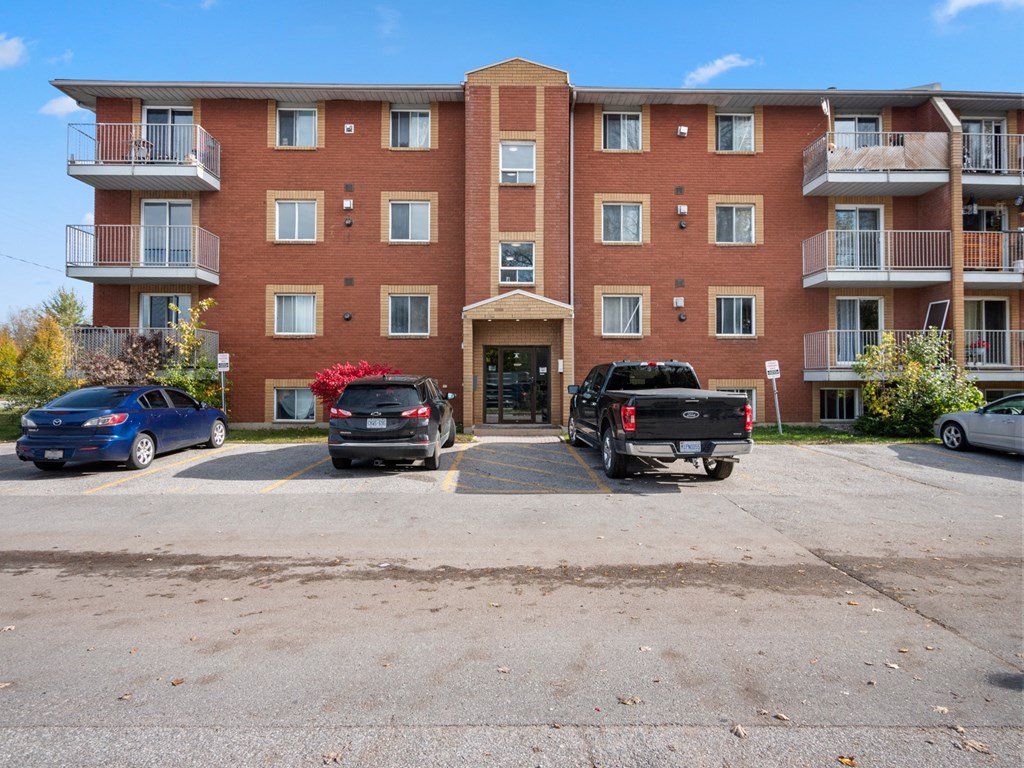 a large brick building with a parking lot in front of it