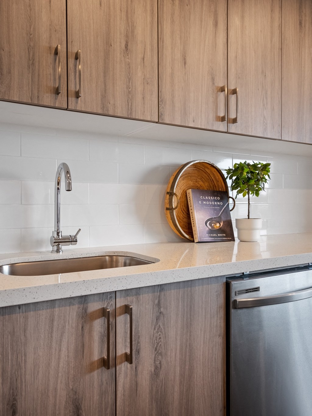 a kitchen with wooden cabinets and a sink