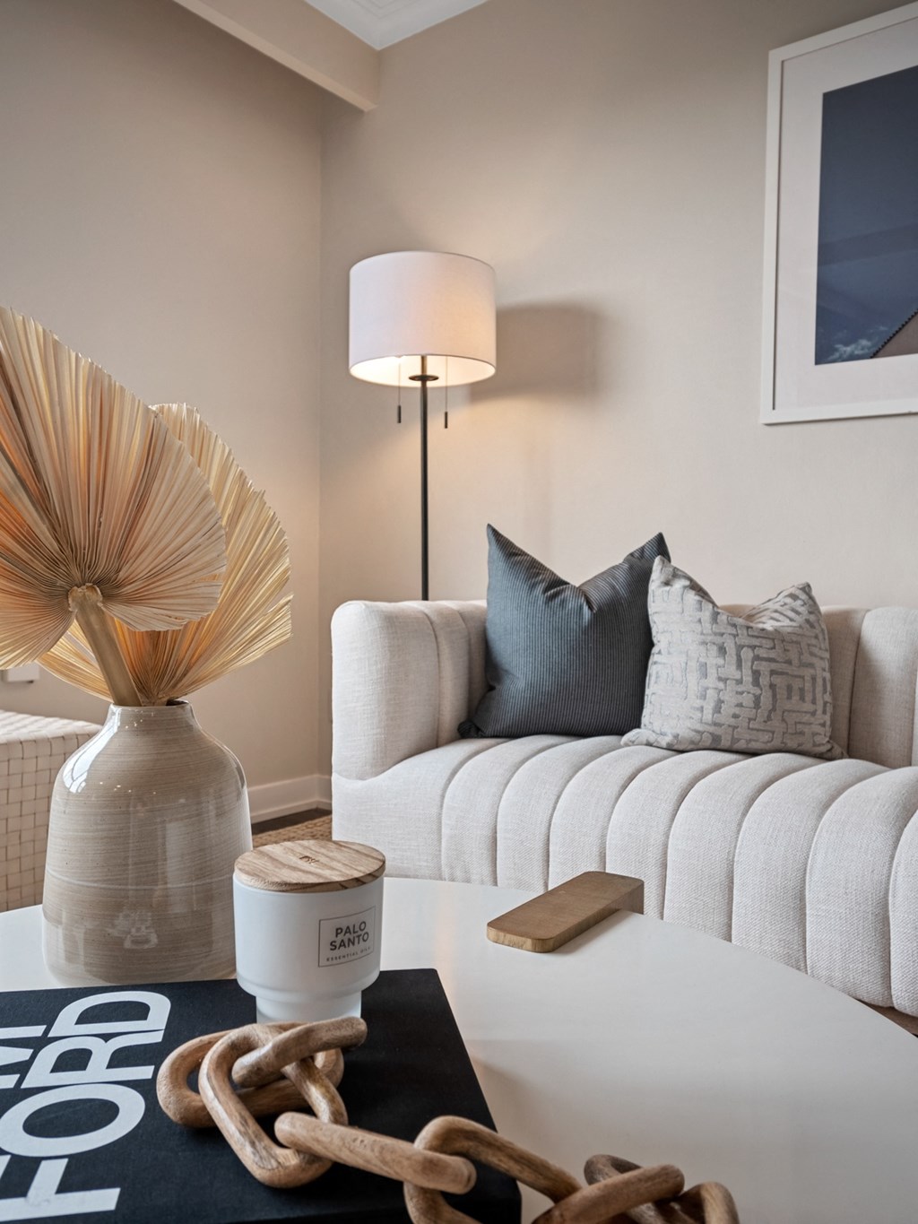 a living room with a white sofa and a white coffee table