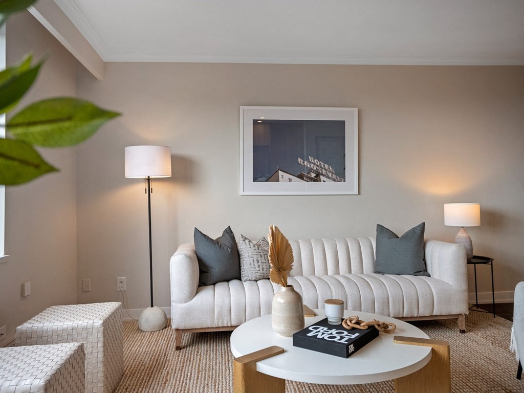 a living room filled with furniture and a large window