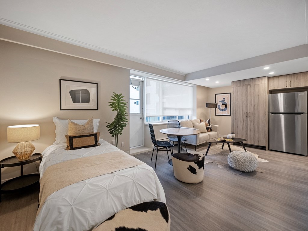 a bedroom with a bed and a couch in a 555 waverly unit