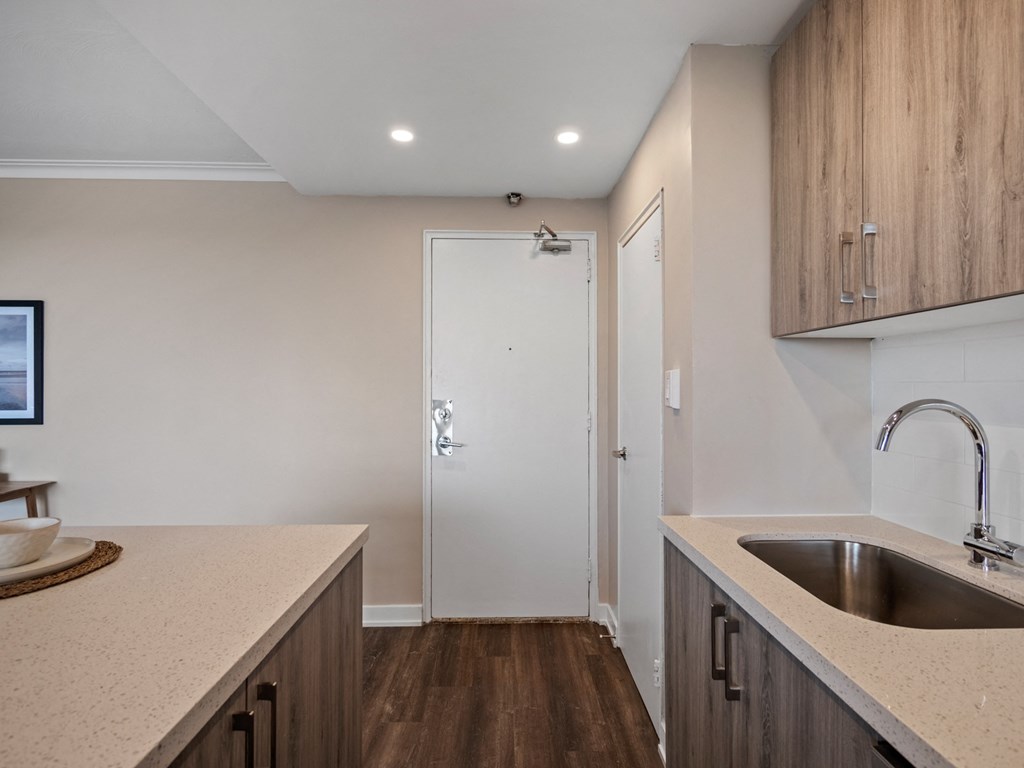a kitchen in a bedroom plus den unit.