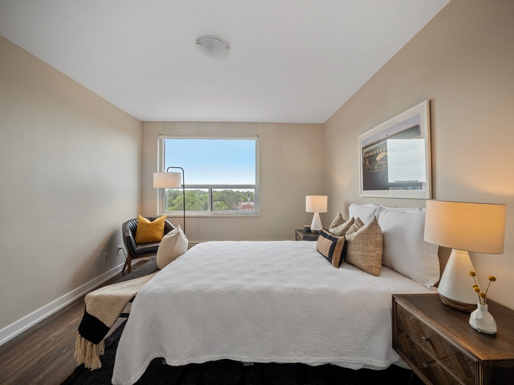 a bedroom with a large bed and a window