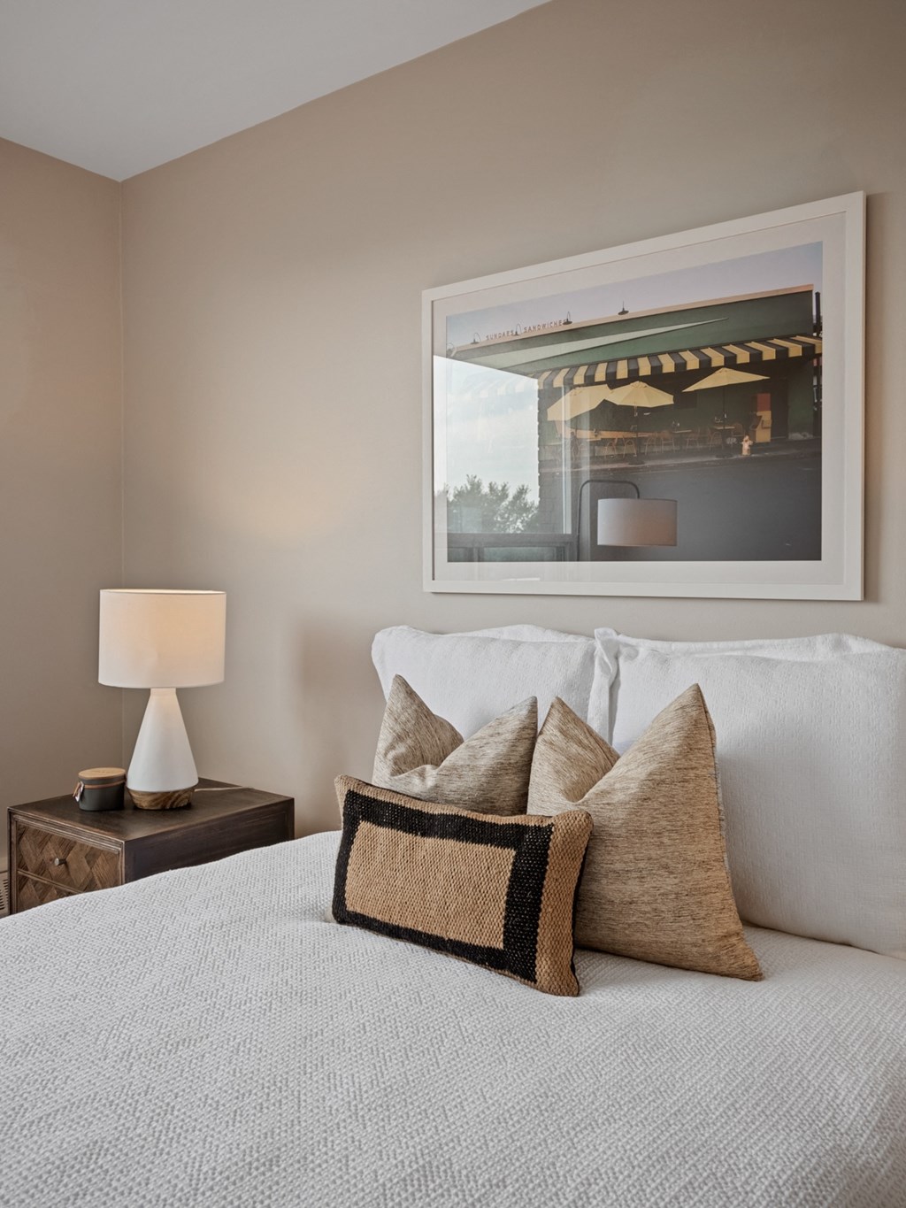 a bedroom with a bed and a nightstand with a lamp