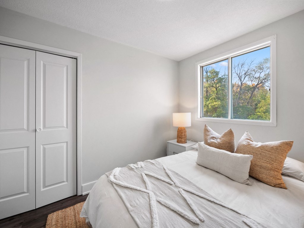 a bedroom with a bed and a window