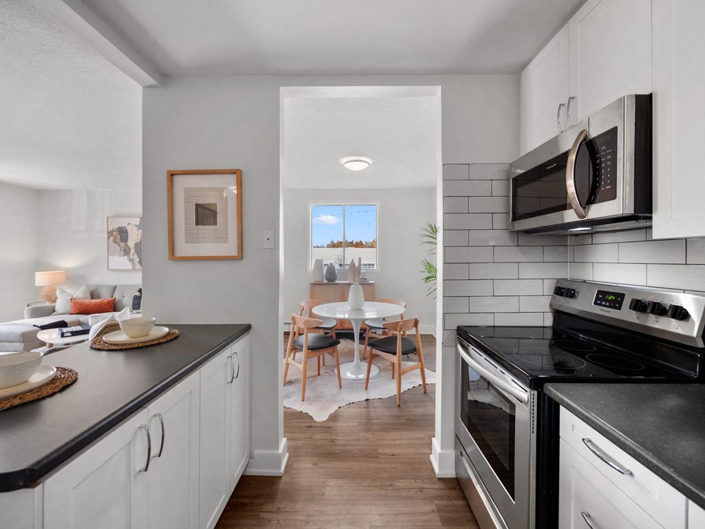 a kitchen and dining area in a 555 waverly unit