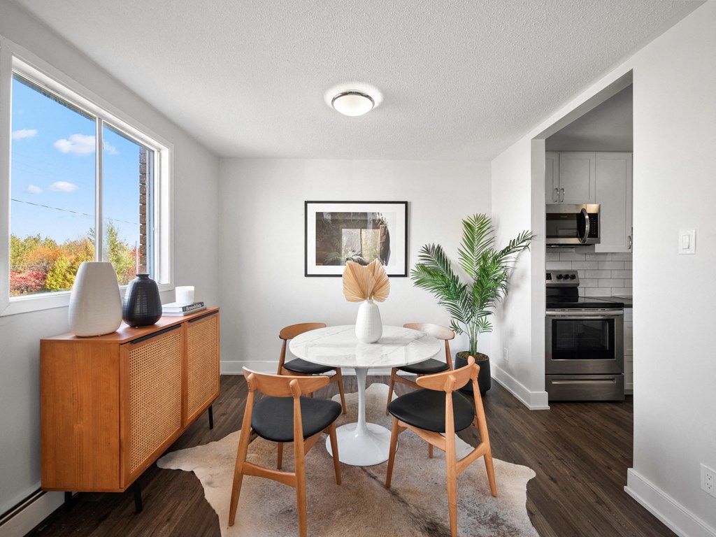 a dining room with a round table and four chairs
