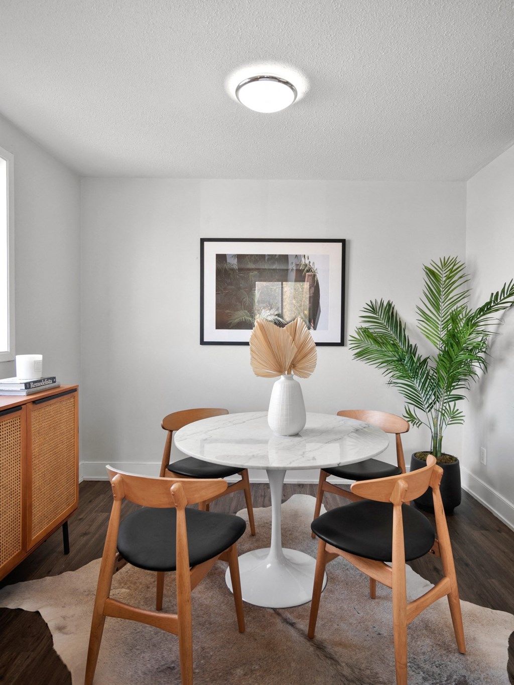 a dining room with a round table and four chairs