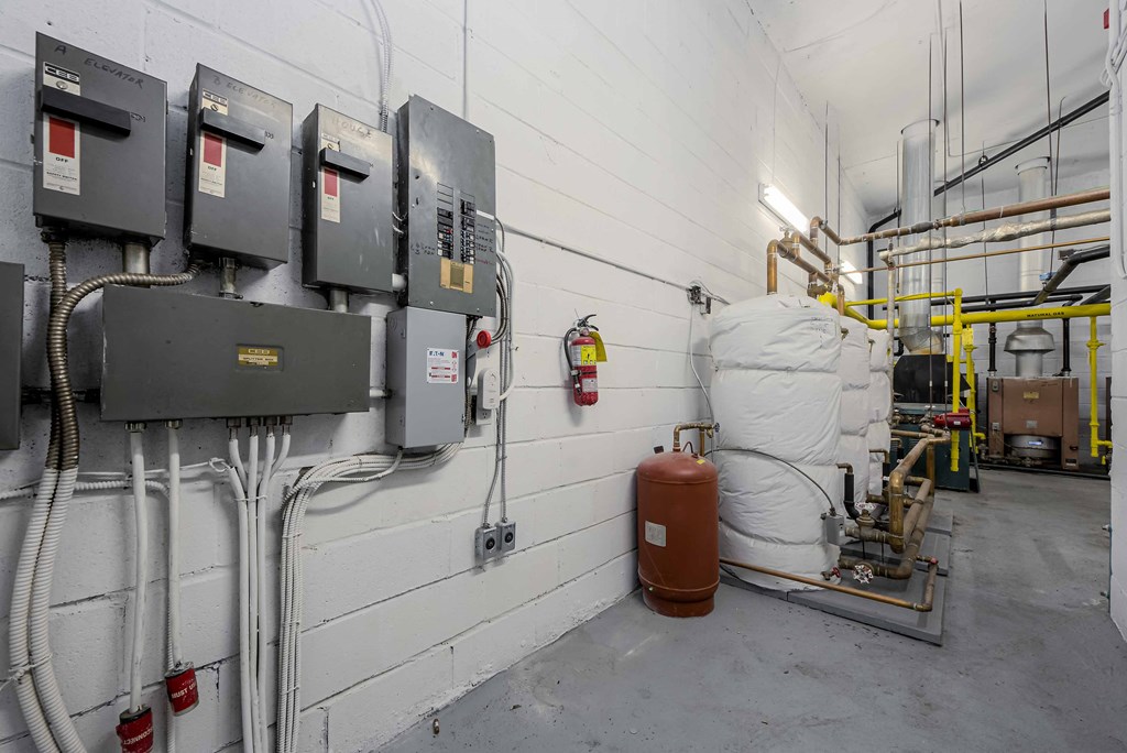 a row of gas meters on a wall with a white wall in the background and a white