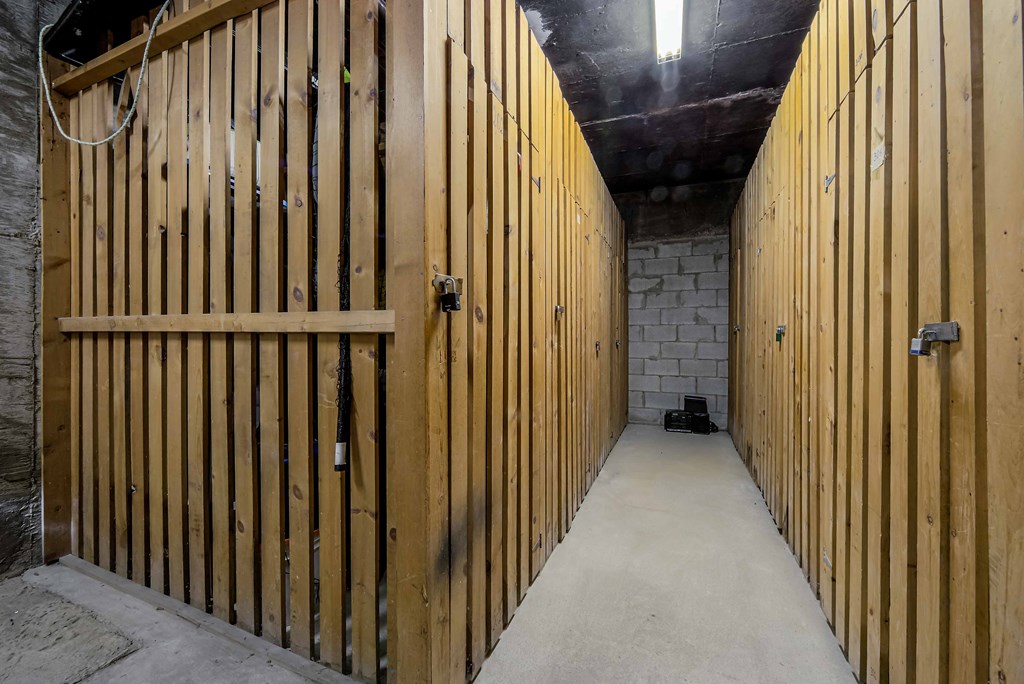a large room with wooden walls and a white brick wall in the background