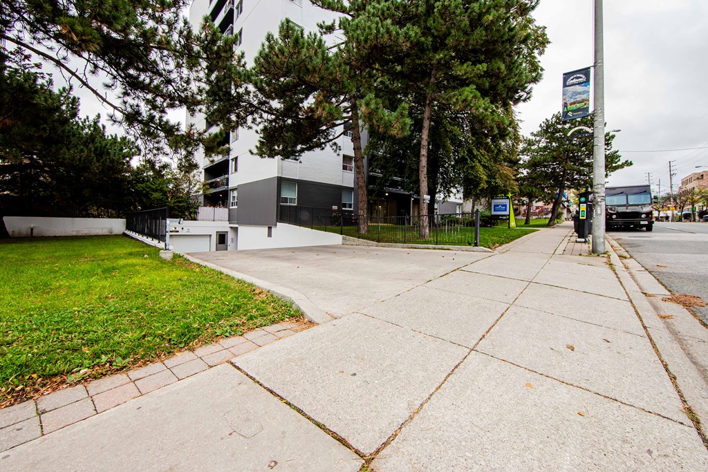 a city street with a white building in the background