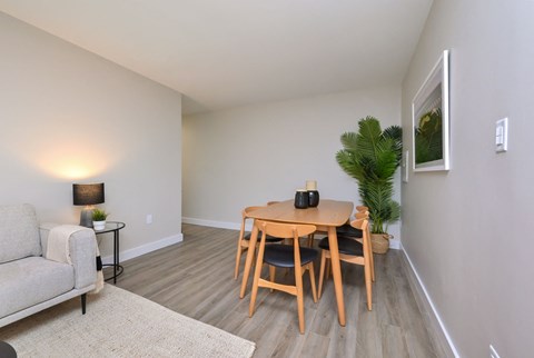 a dining room with a wooden table and chairs