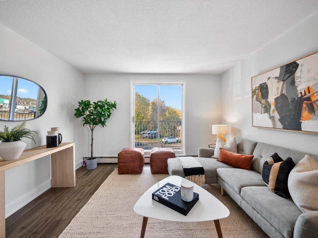 a living room with a large sliding glass door and a view of the parking lot