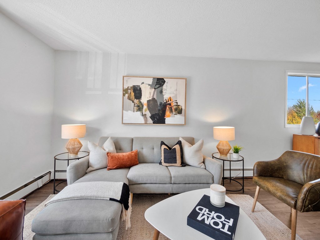 a living room with a gray couch and a white coffee table