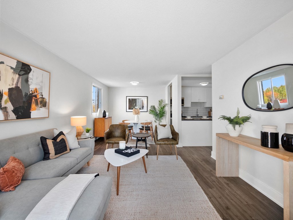 a living room with a gray couch and a white coffee table
