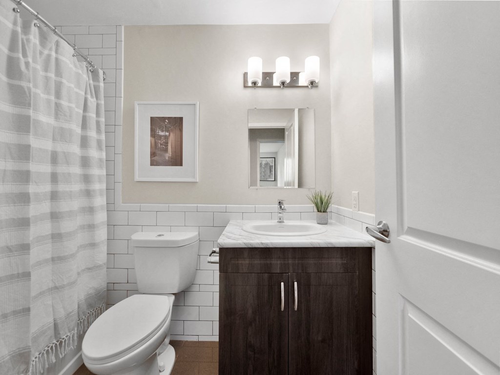 a bathroom with a toilet sink and shower