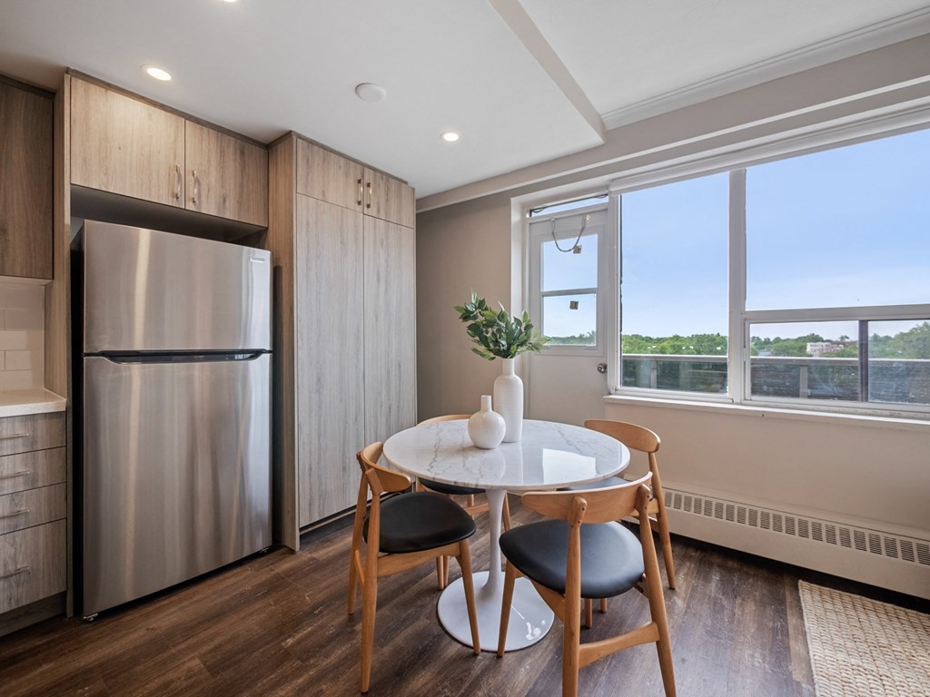 a kitchen with a refrigerator freezer next to a window