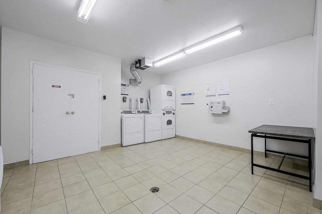 a laundry room with a sink and washer and dryer