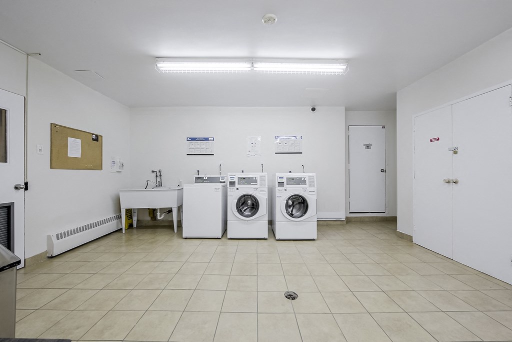 a laundry room with washing machines and a sink