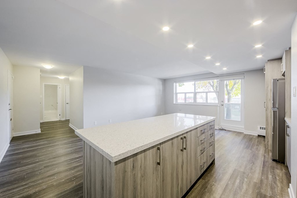 a kitchen with white countertops and a large island