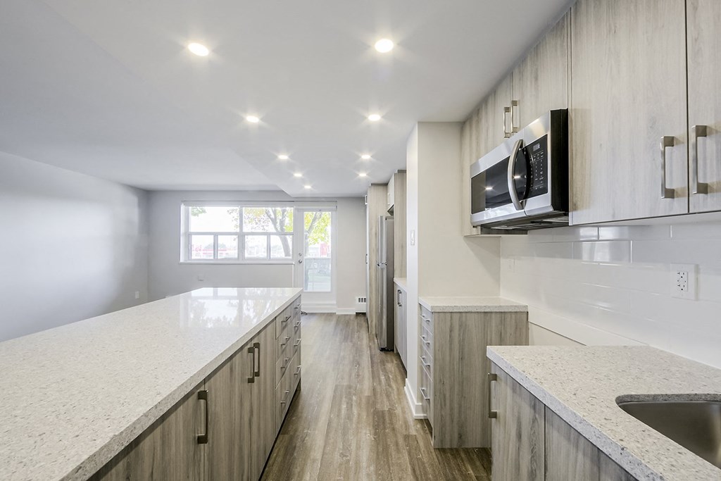 a kitchen with white countertops and white cabinets