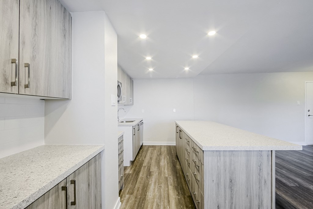 a kitchen with white cabinets and white countertops