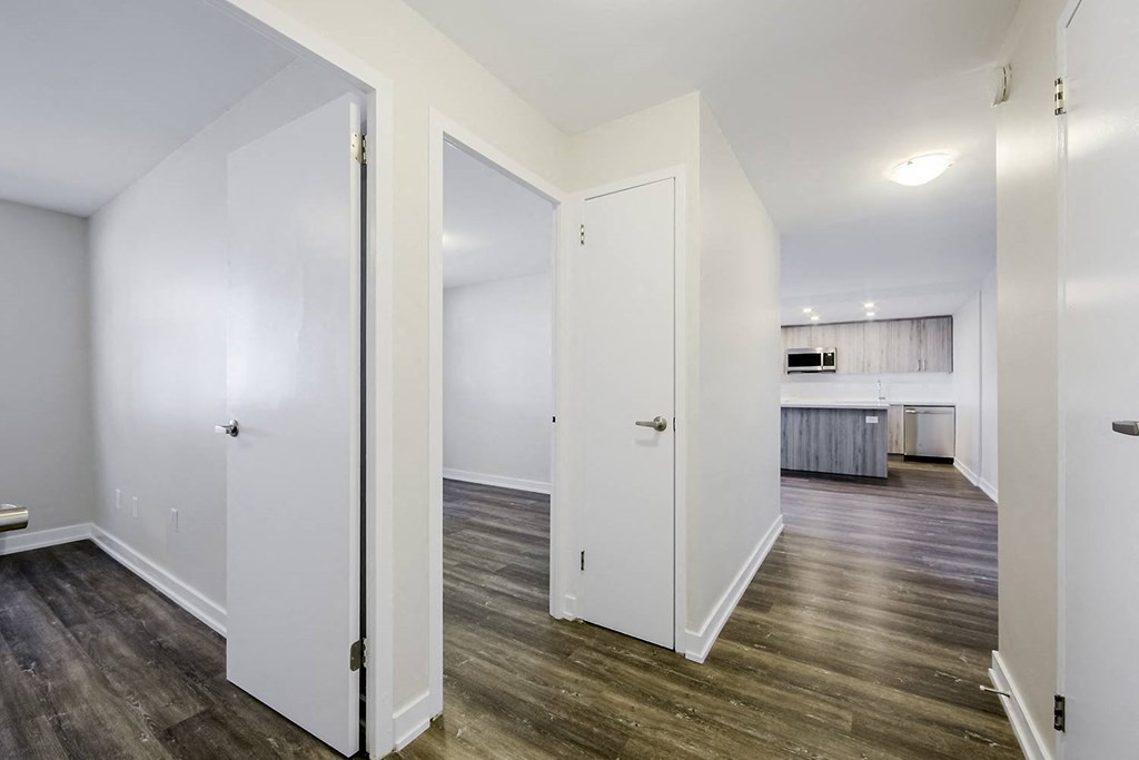 a bedroom with a medium sized bed and a mirror on the wall