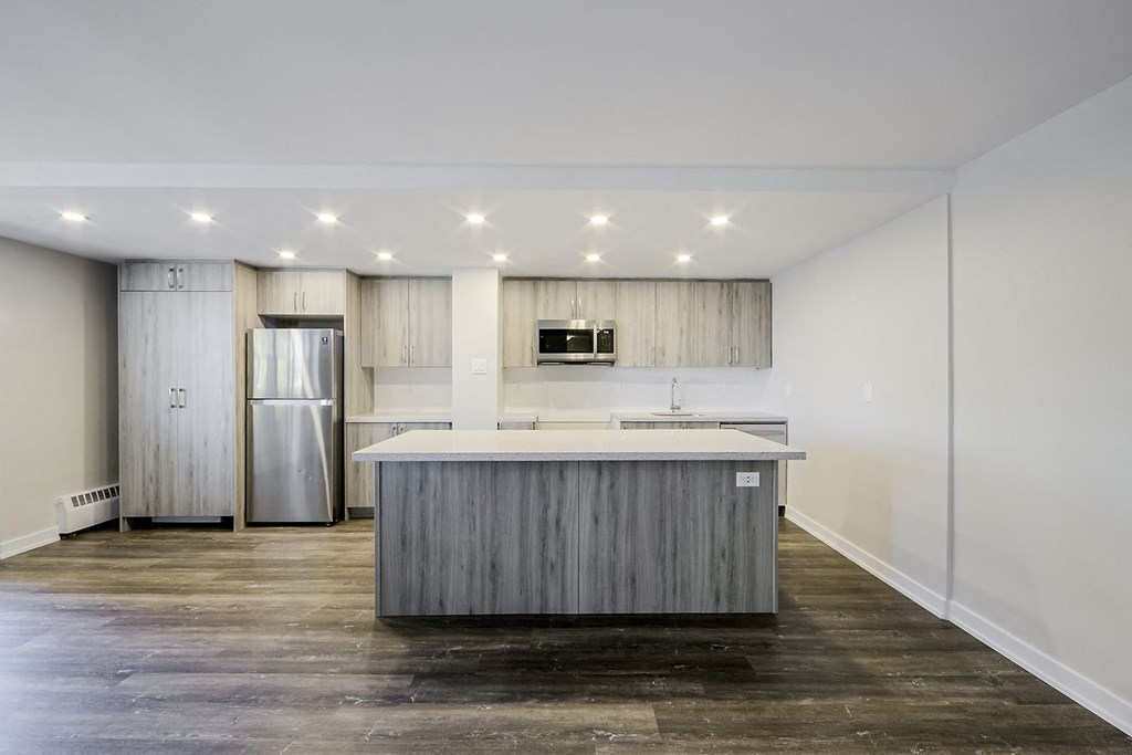 a kitchen with a large island in the middle of it