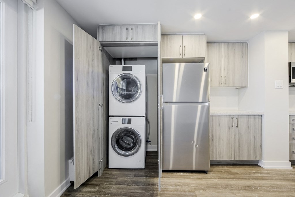a laundry room with a washer and dryer and a refrigerator