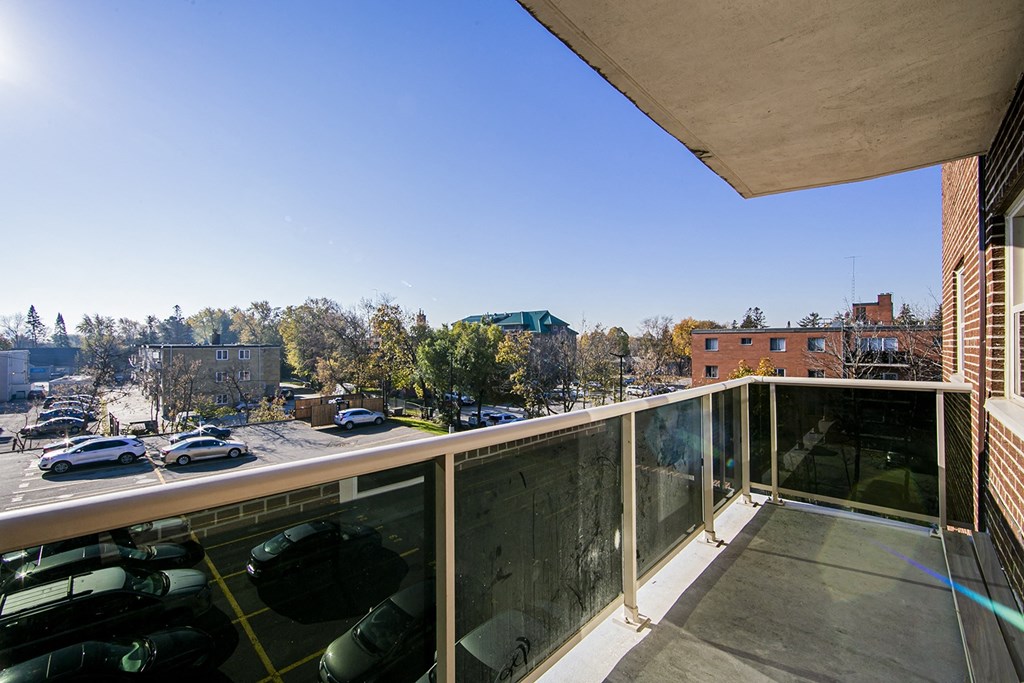a balcony with a view of a parking lot