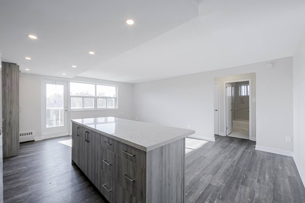 a kitchen with a large island in front of a doorway