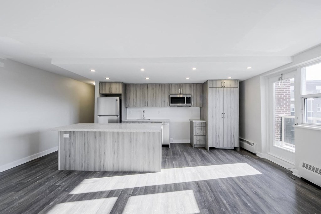 a kitchen with a large center island next to a window