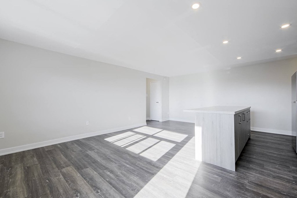 a bedroom with a medium sized bed and a desk in a room with hardwood floors