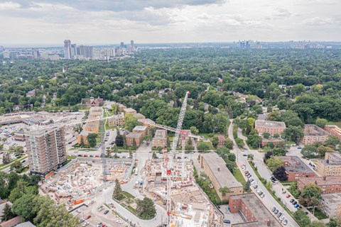 an aerial view of a construction site with a city in the background