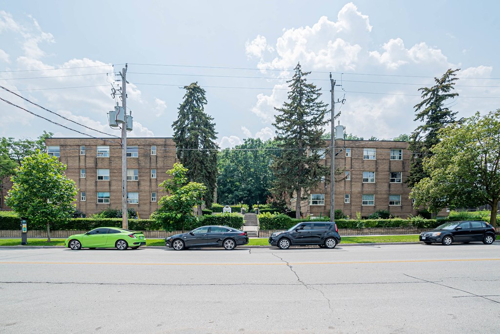 a large brick building with cars parked in front of it