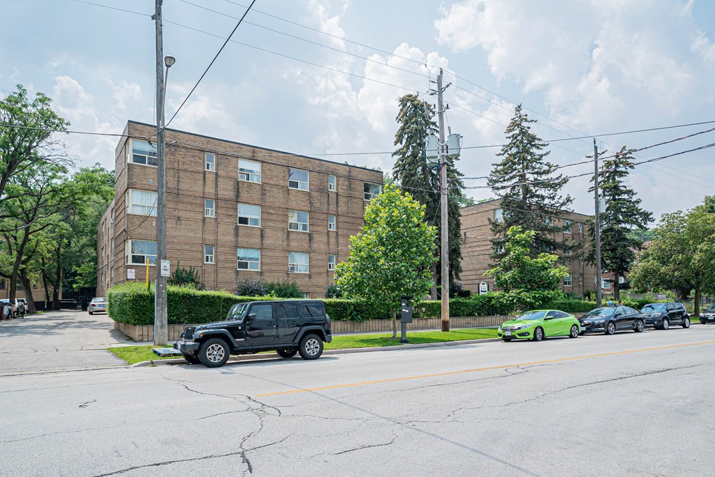 a large brick building with a black jeep parked in front of it