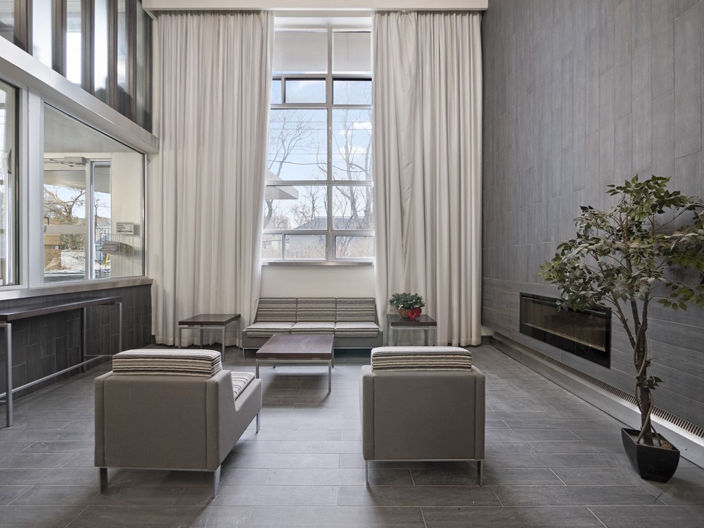 a view of the living room with a large window and a bench in front of it