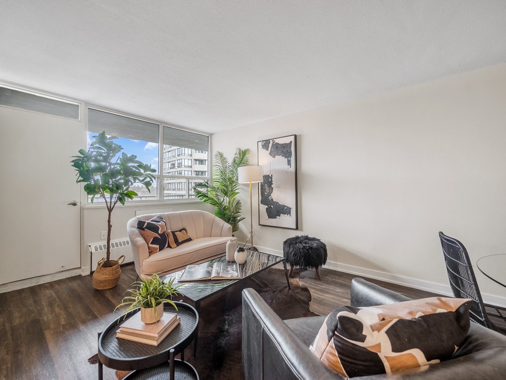 a living room with white walls and a large window