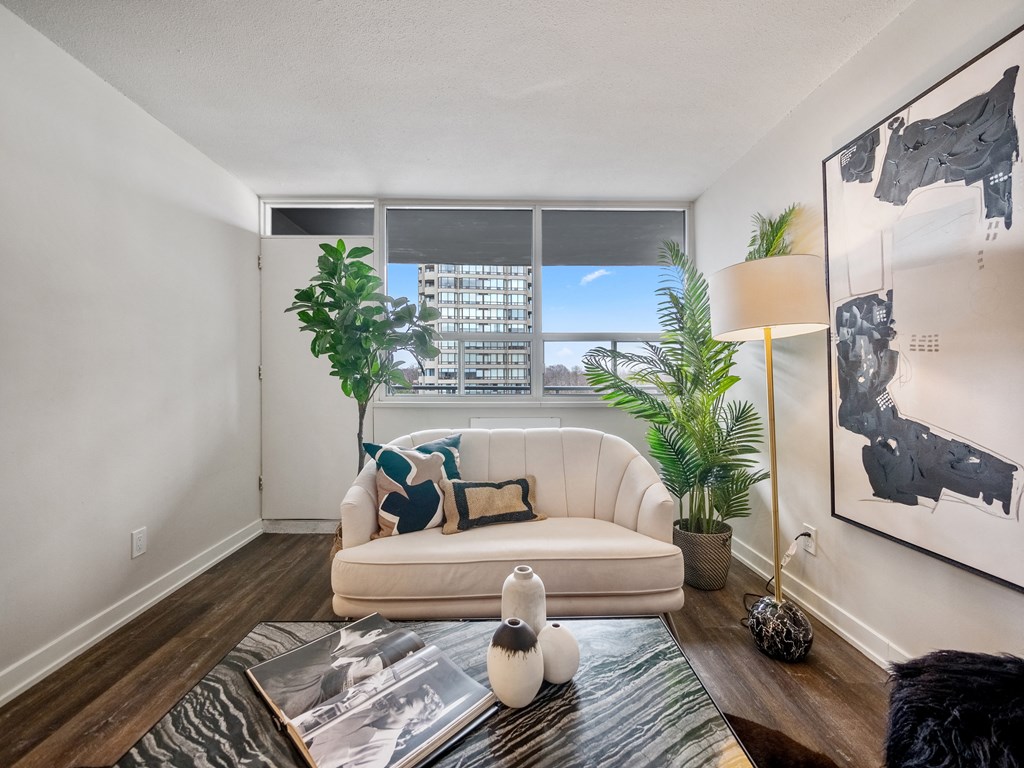 a living room with a white couch and a large window