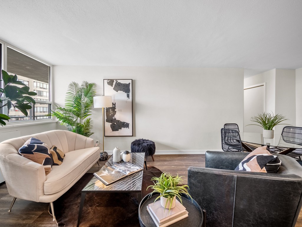 a living room with white walls and a large window