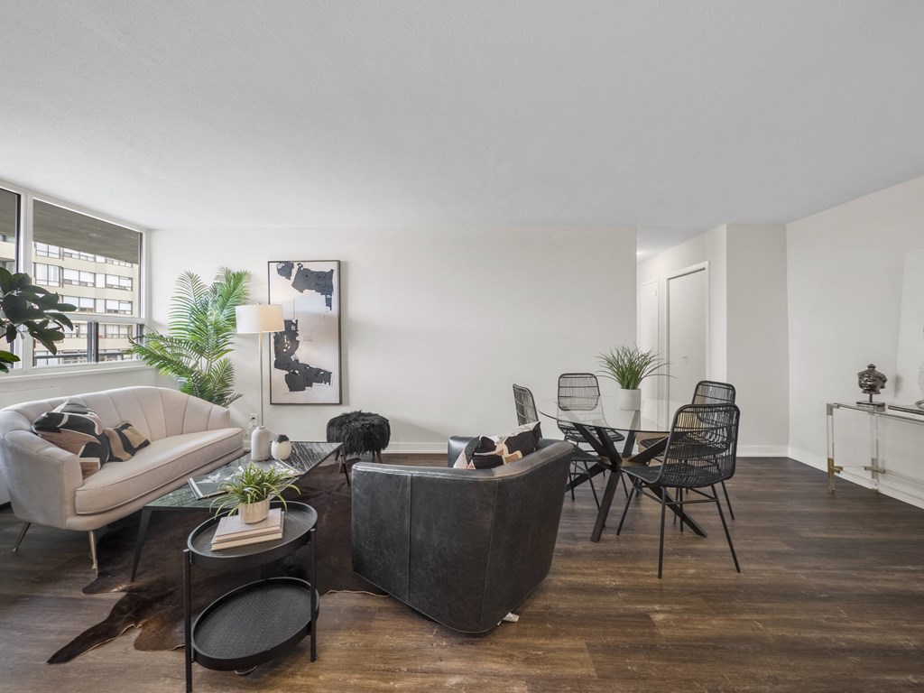 a living room with white walls and hardwood floors