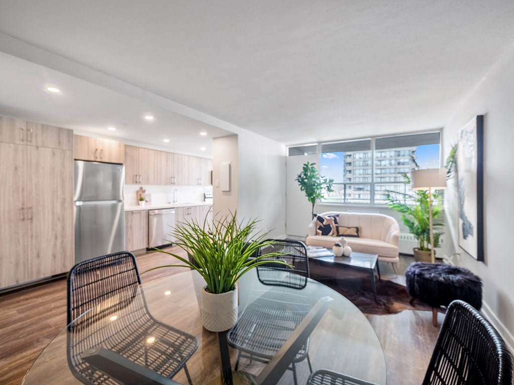 a living room with a glass table and chairs