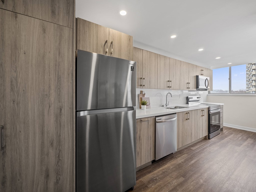 a kitchen with wooden cabinets and stainless steel appliances