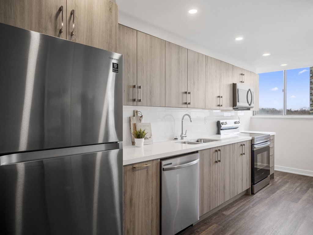a kitchen in a 555 waverly unit with a stainless steel refrigerator and dishwasher
