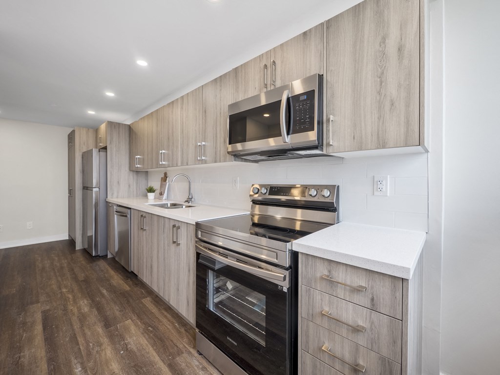 a kitchen with wooden cabinets and stainless steel appliances