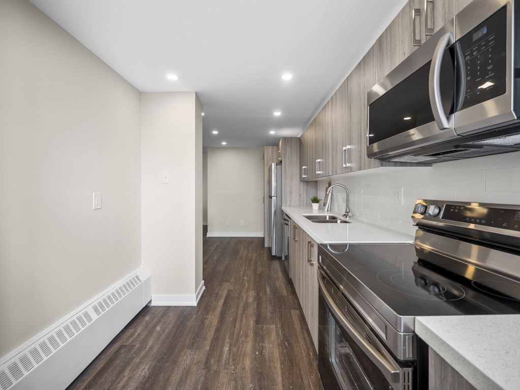 a kitchen with wood floors and white walls