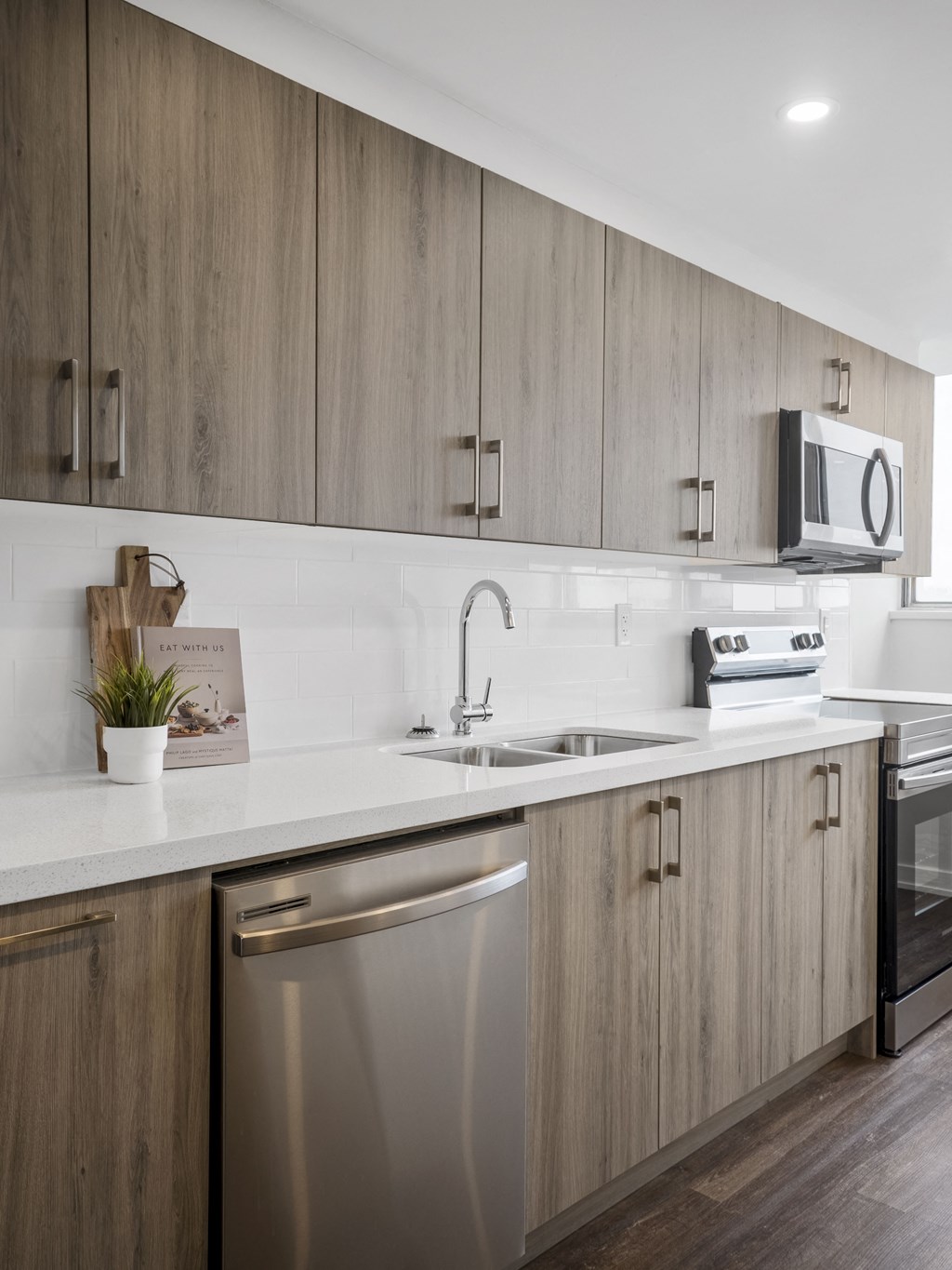 a kitchen with white countertops and wooden cabinets