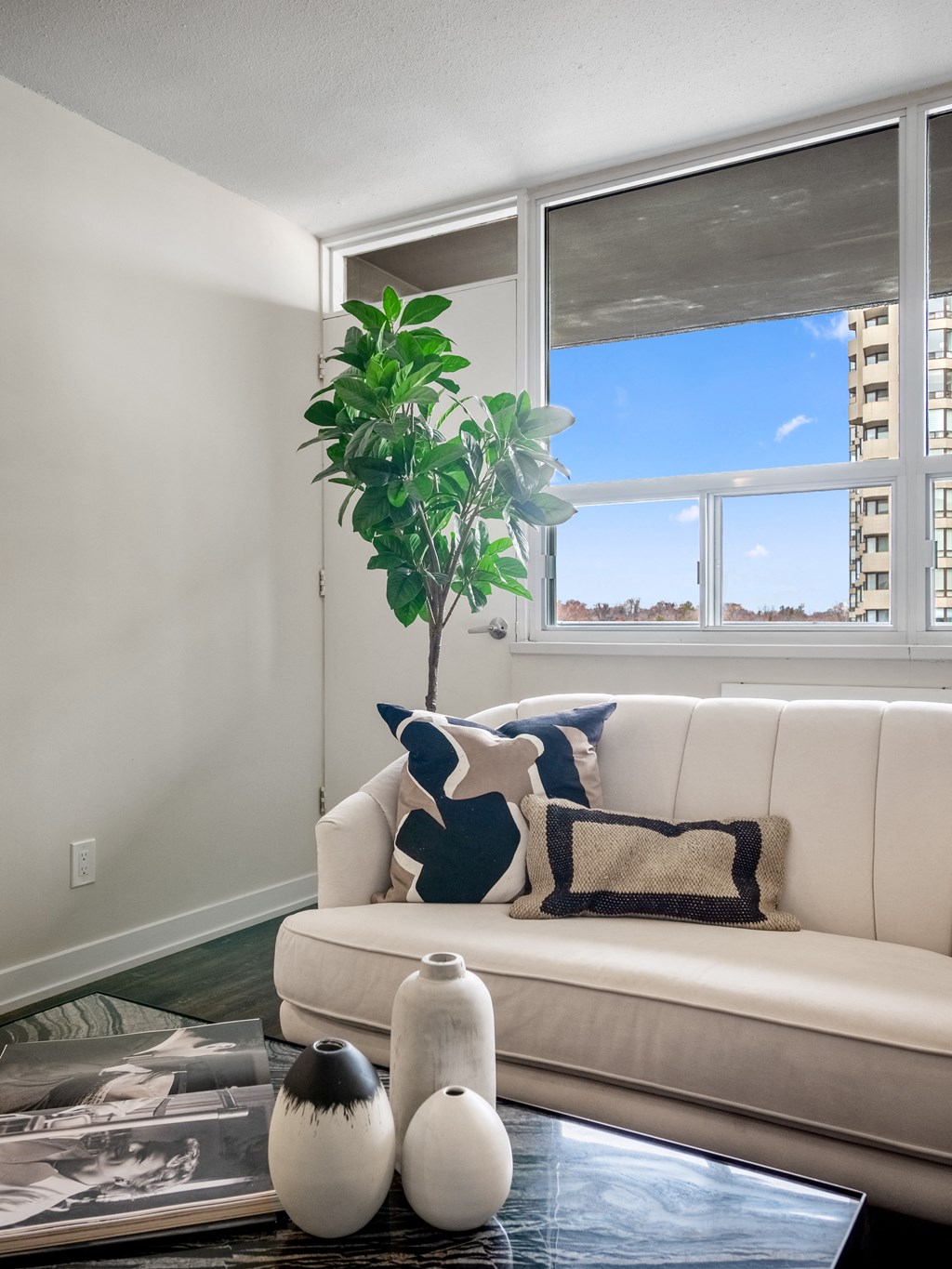 a living room with a white couch and a large window