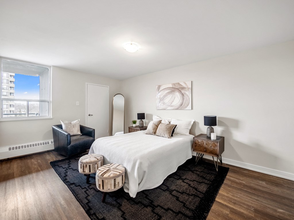 a bedroom with a bed and a chair in a 555 waverly unit